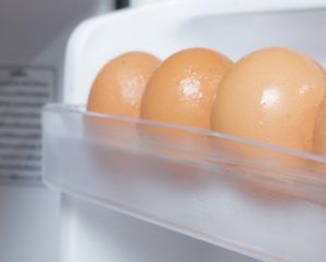 Picture showing egg case in a refrigerator with eggs in it