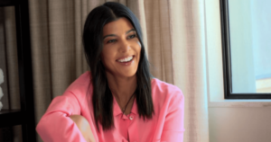 A photograph showing a women with black hair laughing