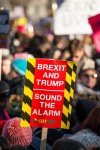 Picture of a pluck card of brexit held by a mob in public