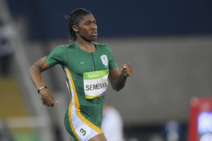 Picture of a running athlete women wearing green jersey