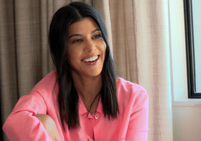 A photograph showing a women with black hair laughing