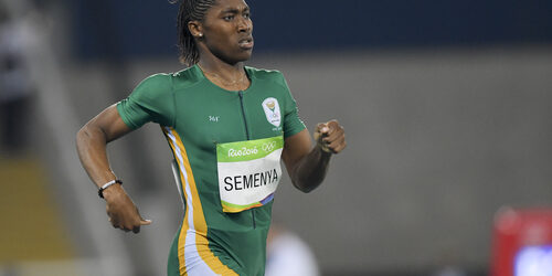 Picture of a running athlete women wearing green jersey