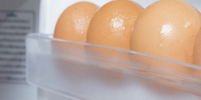 Picture showing egg case in a refrigerator with eggs in it