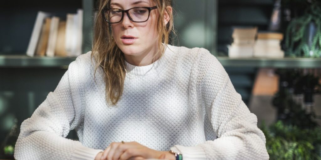 A close up picture showing a women sitting on a table